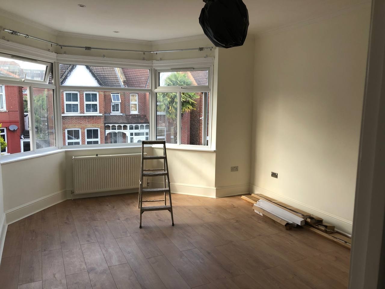Laminate flooring installation in bay window room — West London