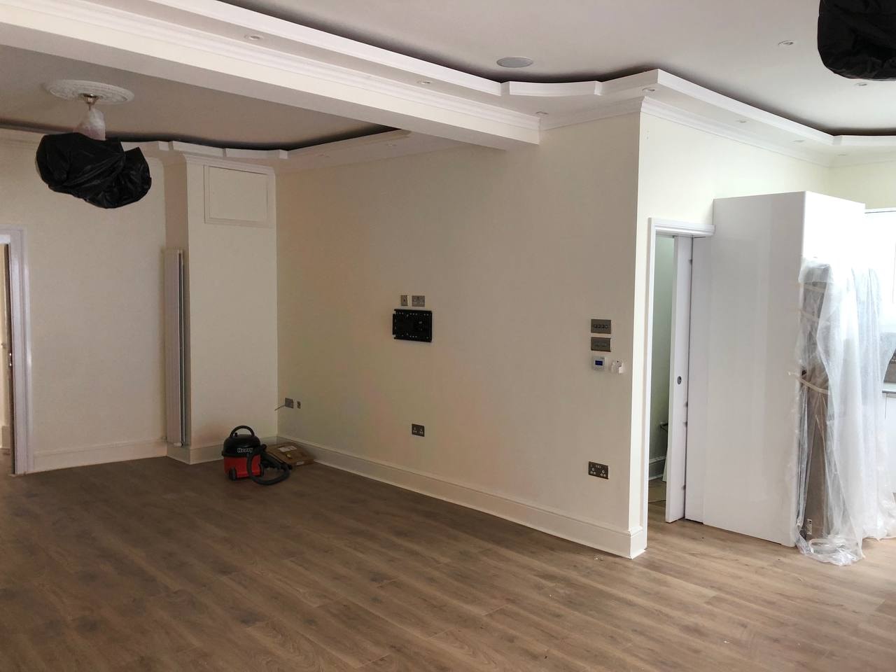 Completed open-plan room with new wood laminate flooring — West London