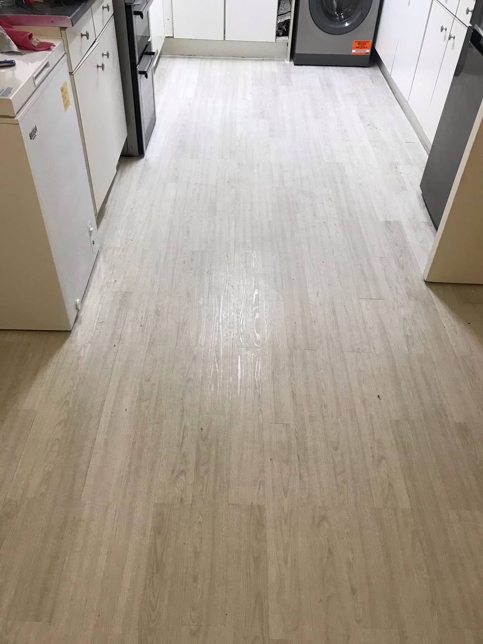 Light grey vinyl flooring fitted in kitchen — West London