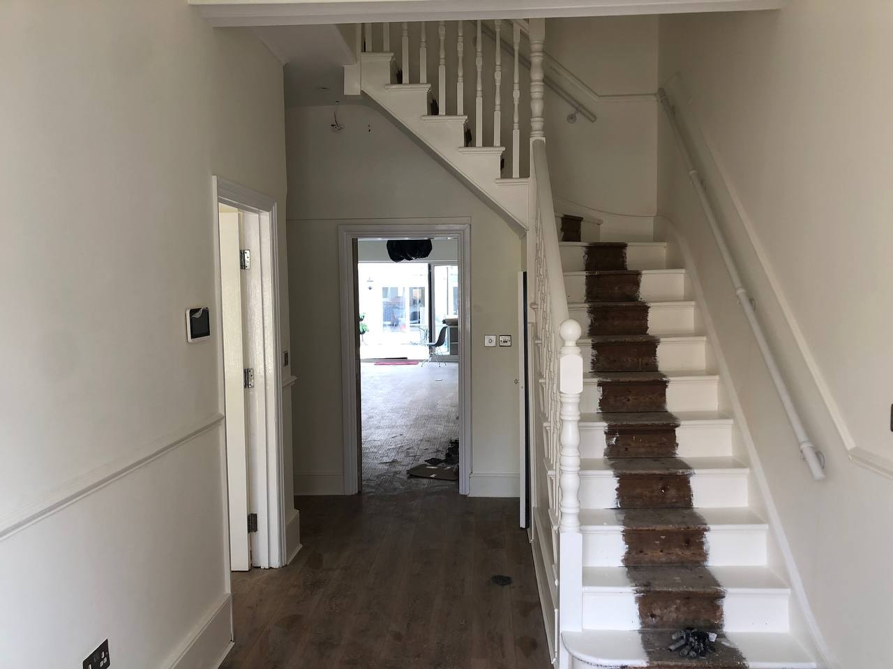 Hallway and staircase painting with white woodwork — West London