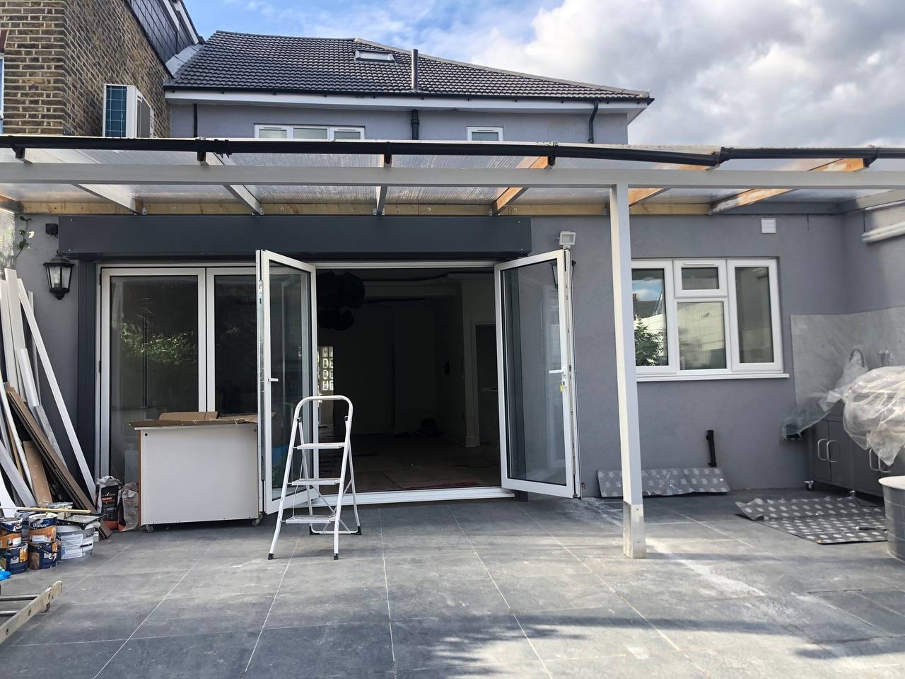 Property extension with pergola and bi-fold doors — West London