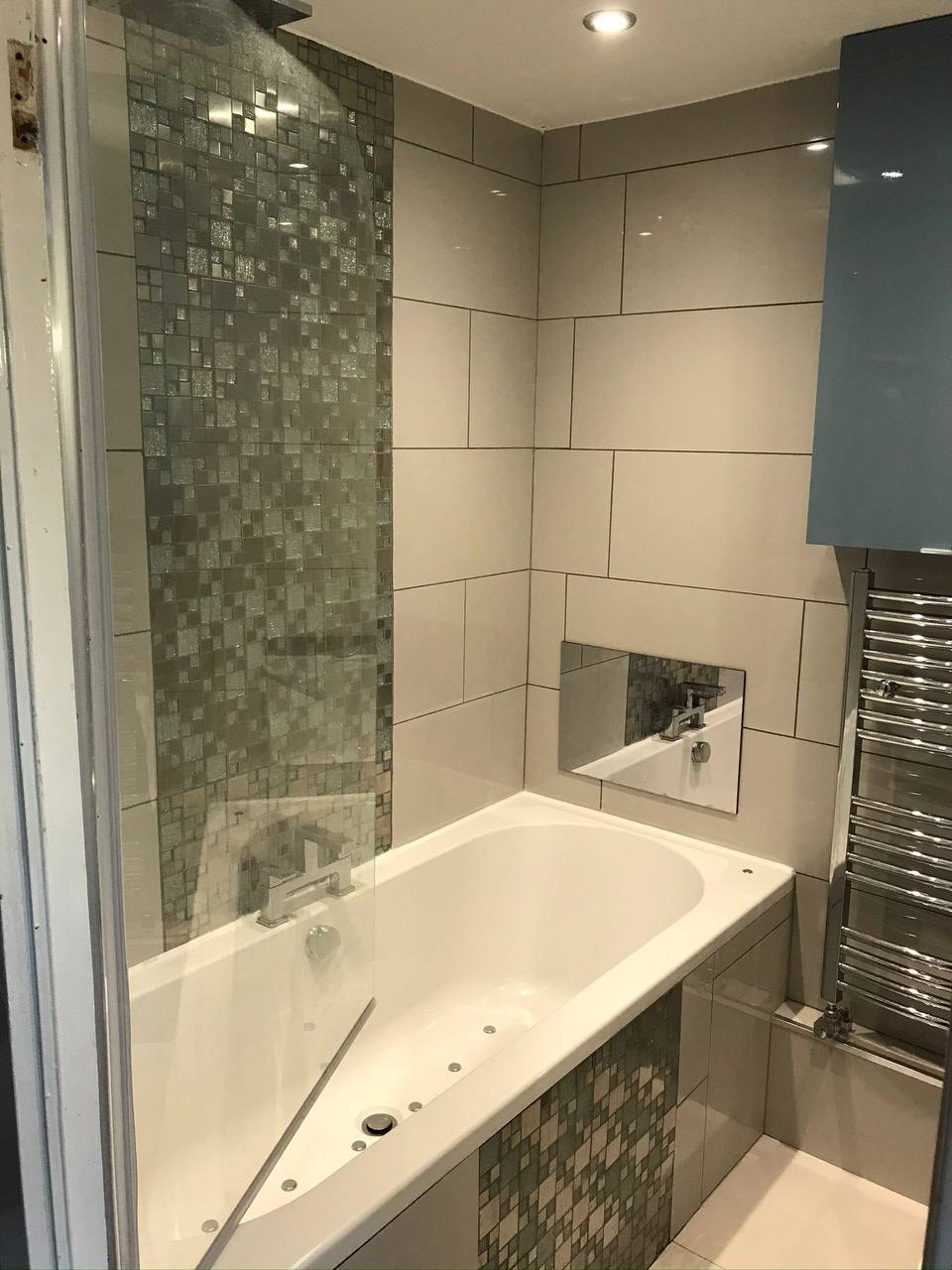 Bathroom wall tiling with mosaic feature and bath — West London